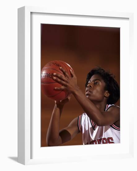 Female High Schooll Basketball Player in Action Shooting a Free Throw During a Game-null-Framed Photographic Print