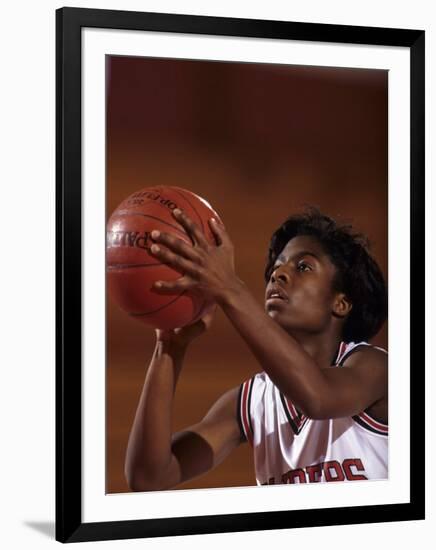 Female High Schooll Basketball Player in Action Shooting a Free Throw During a Game-null-Framed Photographic Print