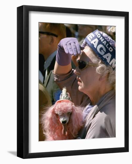 Female Holding Pink Poodle Wearing Hat Emblazoned with Reagan During Campaign Speech-Bill Ray-Framed Photographic Print
