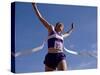 Female Runner Celebrates Victory at the Finish Line-null-Stretched Canvas