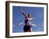 Female Runner Celebrates Victory at the Finish Line-null-Framed Photographic Print