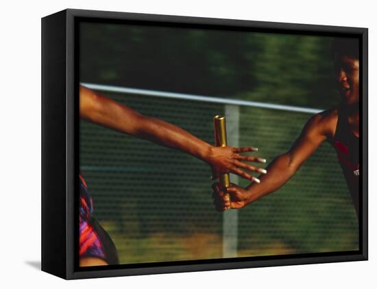 Female Runner Competing in a Relay Track Race-null-Framed Stretched Canvas