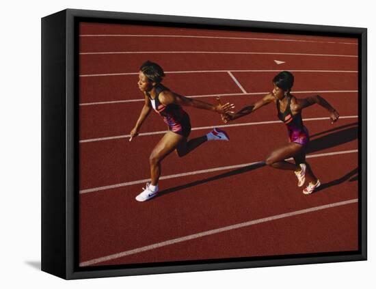 Female Runner Competing in a Relay Track Race-null-Framed Stretched Canvas