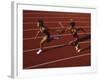 Female Runner Competing in a Relay Track Race-null-Framed Photographic Print