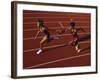 Female Runner Competing in a Relay Track Race-null-Framed Photographic Print