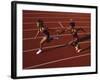 Female Runner Competing in a Relay Track Race-null-Framed Photographic Print