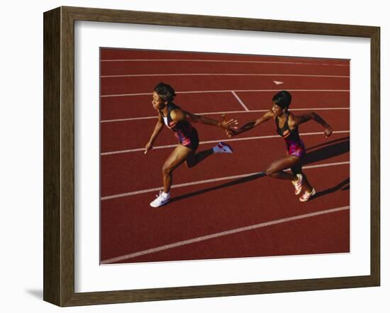 Female Runner Competing in a Relay Track Race-null-Framed Photographic Print