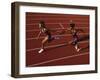 Female Runner Competing in a Relay Track Race-null-Framed Photographic Print