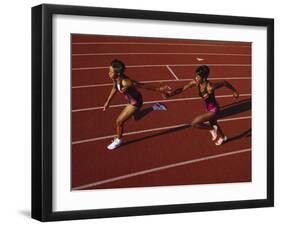 Female Runner Competing in a Relay Track Race-null-Framed Photographic Print