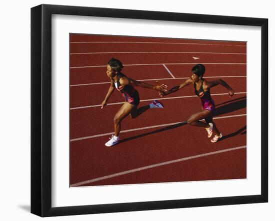 Female Runner Competing in a Relay Track Race-null-Framed Photographic Print