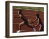 Female Runner Competing in a Relay Track Race-null-Framed Photographic Print