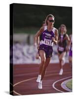 Female Runner Competing in a Track Race-null-Stretched Canvas
