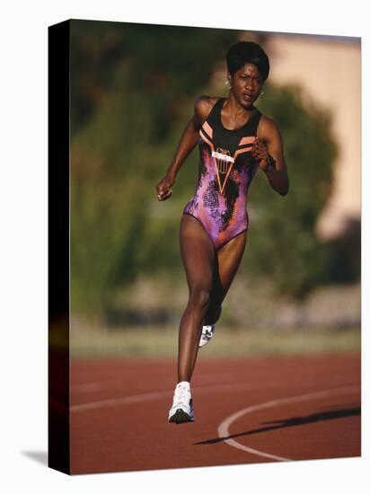 Female Runner Competing in a Track Race-null-Stretched Canvas