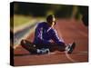 Female Runner Stretching While Training on the Track-null-Stretched Canvas