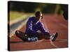 Female Runner Stretching While Training on the Track-null-Stretched Canvas