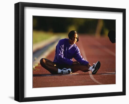 Female Runner Stretching While Training on the Track-null-Framed Photographic Print