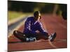 Female Runner Stretching While Training on the Track-null-Mounted Photographic Print