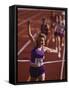 Female Runner Victorious at the Finish Line in a Track Race-null-Framed Stretched Canvas