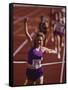 Female Runner Victorious at the Finish Line in a Track Race-null-Framed Stretched Canvas