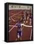 Female Runner Victorious at the Finish Line in a Track Race-null-Framed Stretched Canvas