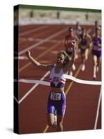 Female Runner Victorious at the Finish Line in a Track Race-null-Stretched Canvas