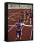 Female Runner Victorious at the Finish Line in a Track Race-null-Framed Stretched Canvas