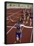 Female Runner Victorious at the Finish Line in a Track Race-null-Framed Stretched Canvas