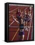 Female Runner Victorious at the Finish Line in a Track Race-null-Framed Stretched Canvas