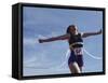 Female Runner Victorious at the Finish Line in a Track Race-null-Framed Stretched Canvas