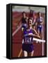 Female Runner Victorious at the Finish Line in a Track Race-null-Framed Stretched Canvas