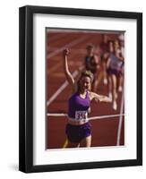 Female Runner Victorious at the Finish Line in a Track Race-null-Framed Premium Photographic Print