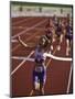 Female Runner Victorious at the Finish Line in a Track Race-null-Mounted Premium Photographic Print