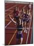 Female Runner Victorious at the Finish Line in a Track Race-null-Mounted Photographic Print