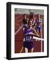 Female Runner Victorious at the Finish Line in a Track Race-null-Framed Photographic Print