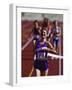 Female Runner Victorious at the Finish Line in a Track Race-null-Framed Photographic Print