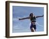 Female Runner Victorious at the Finish Line in a Track Race-null-Framed Photographic Print