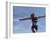 Female Runner Victorious at the Finish Line in a Track Race-null-Framed Photographic Print