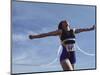 Female Runner Victorious at the Finish Line in a Track Race-null-Mounted Photographic Print