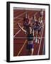 Female Runner Victorious at the Finish Line in a Track Race-null-Framed Photographic Print