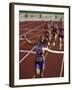 Female Runner Victorious at the Finish Line in a Track Race-null-Framed Photographic Print