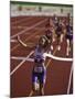 Female Runner Victorious at the Finish Line in a Track Race-null-Mounted Photographic Print