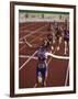 Female Runner Victorious at the Finish Line in a Track Race-null-Framed Photographic Print