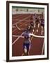 Female Runner Victorious at the Finish Line in a Track Race-null-Framed Photographic Print