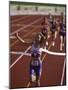 Female Runner Victorious at the Finish Line in a Track Race-null-Mounted Photographic Print