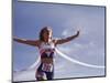 Female Runner Victorious at the Finish Line in a Track Race-null-Mounted Photographic Print