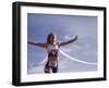 Female Runner Victorious at the Finish Line in a Track Race-null-Framed Photographic Print