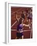 Female Runner Victorious at the Finish Line in a Track Race-null-Framed Photographic Print