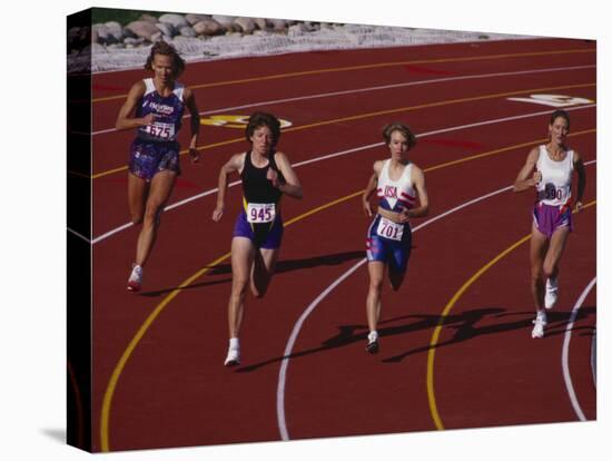 Female Runners Competing in a Track Race-null-Stretched Canvas
