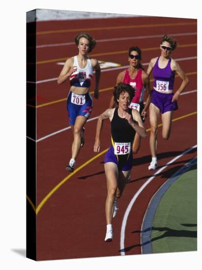 Female Runners Competing in a Track Race-null-Stretched Canvas