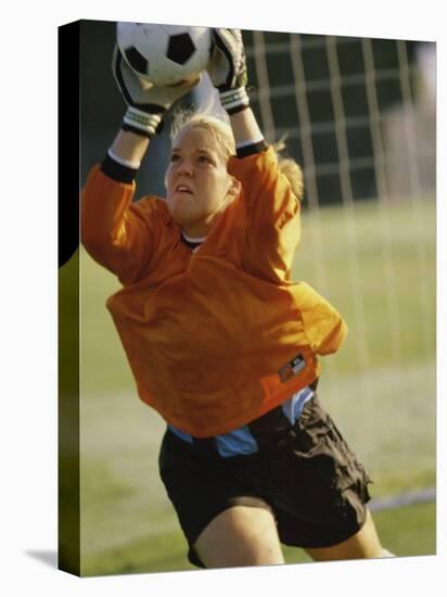 Female Soccer Goalie Catching the Ball-null-Stretched Canvas